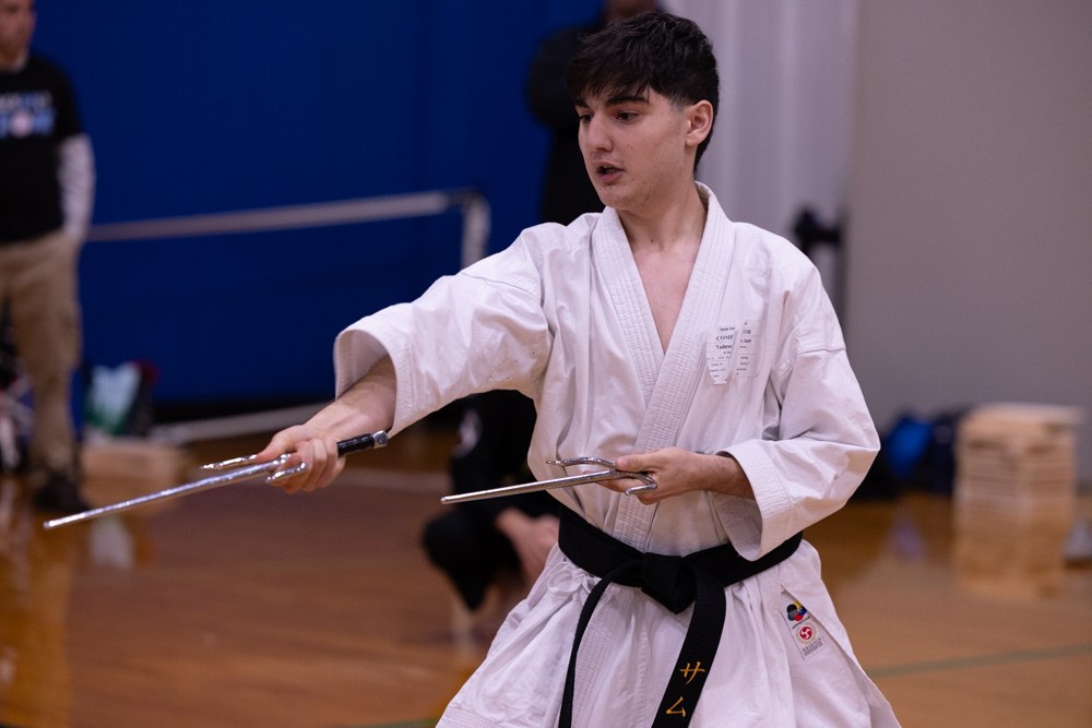 Competitor performing a kata with sai